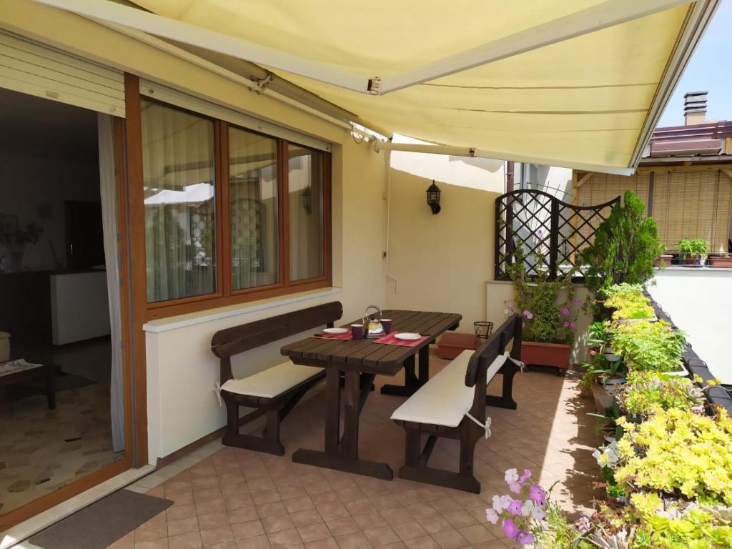 patio con tavolo, sedie e ombrellone di Appartamento Elisabetta a Lido di Venezia