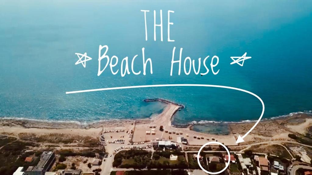 a beach house with the words the beach house at Beach Front Villa in Shave Ẕiyyon