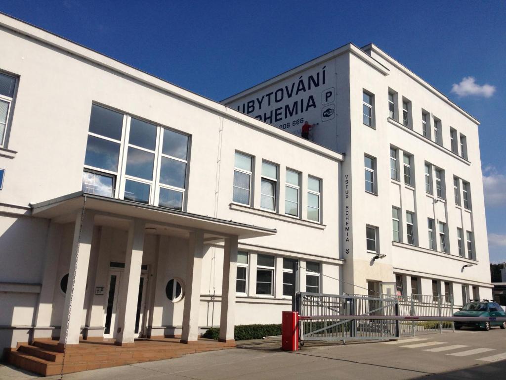 a white building with a sign on the side of it at Hostel Bohemia in Prague