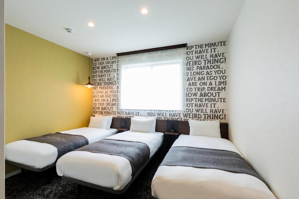 Postel nebo postele na pokoji v ubytování M's Hotel Gojo Odawara