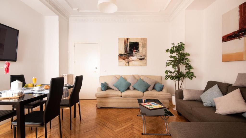 ein Wohnzimmer mit einem Sofa und einem Tisch in der Unterkunft Heima Puerta del Sol - Opera Center in Madrid