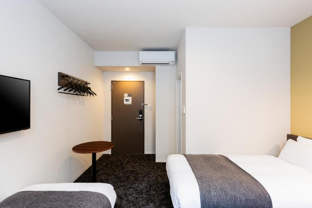 Postel nebo postele na pokoji v ubytování M's Hotel Gojo Odawara
