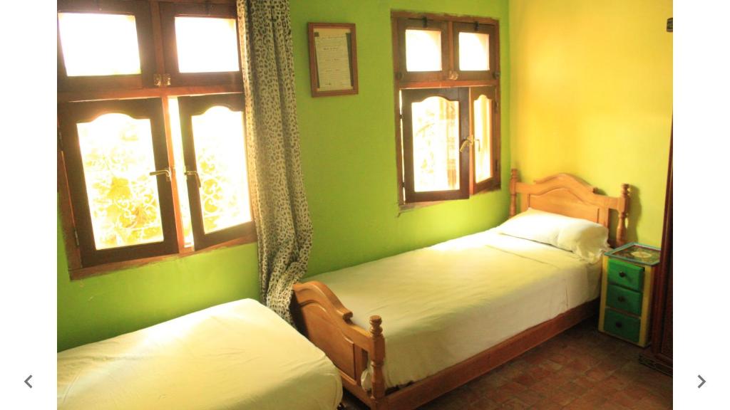 Una cama o camas en una habitación de Harmony Hotel