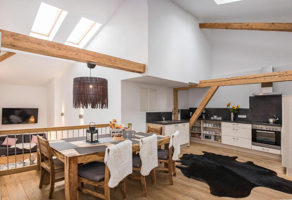 a kitchen and dining room with a table and chairs at Wendelstein Lodge in Fischbachau