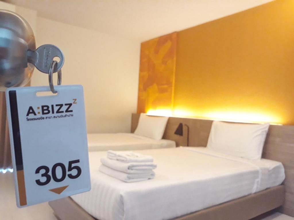 Postel nebo postele na pokoji v ubytování ABIZZ Hotel Lampang Airport