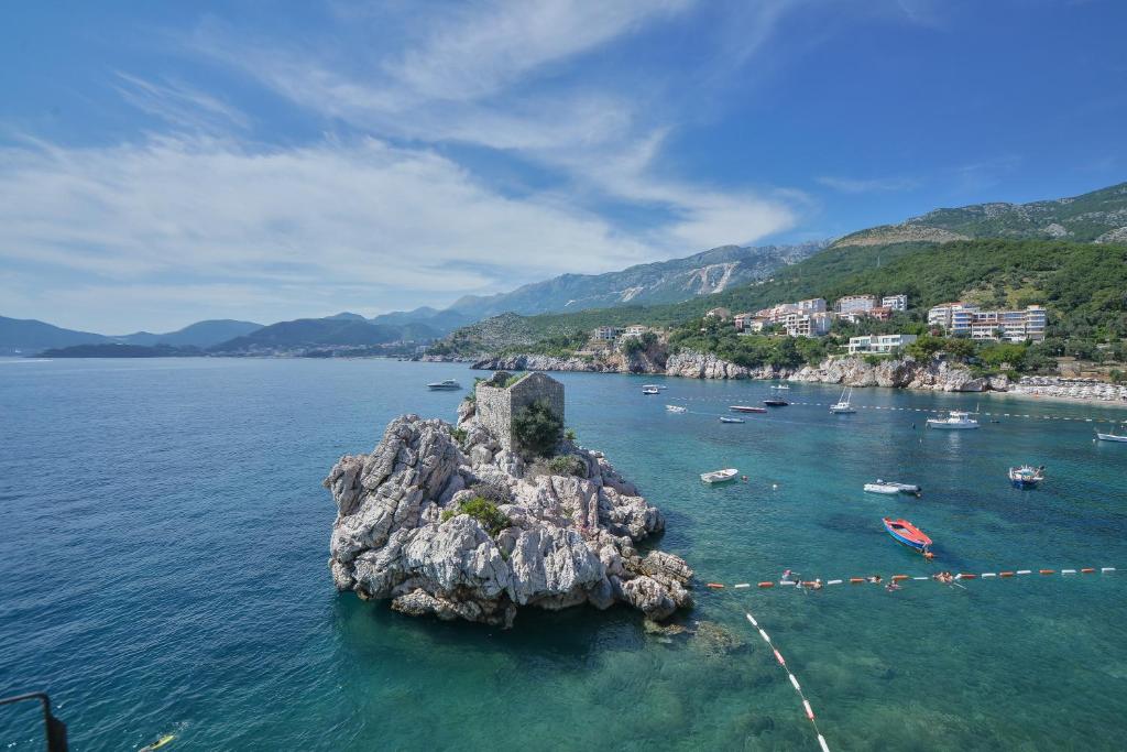 a small island in the middle of a body of water at Kazanegra Exclusive Apartments in Sveti Stefan