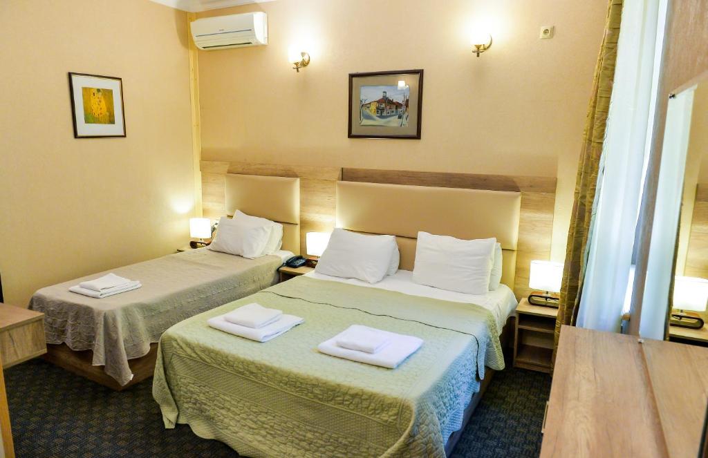 Postel nebo postele na pokoji v ubytování Hotel Old Town