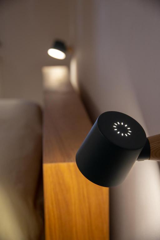 a black remote control hanging from a wall at La Casetta - Rooms & Garden in San Ferdinando