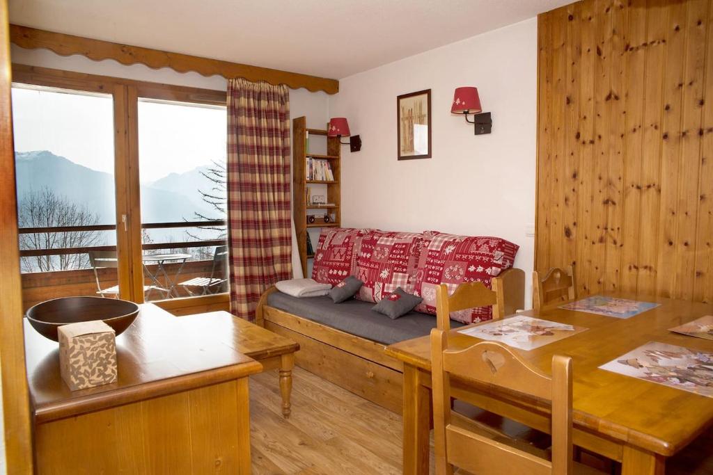 a living room with a couch and a table and a dining room at Marmottin1 in Puy-Saint-Vincent