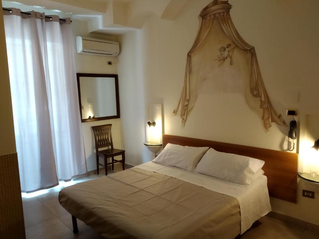 Postel nebo postele na pokoji v ubytování Hotel Vittorio Veneto Napoli