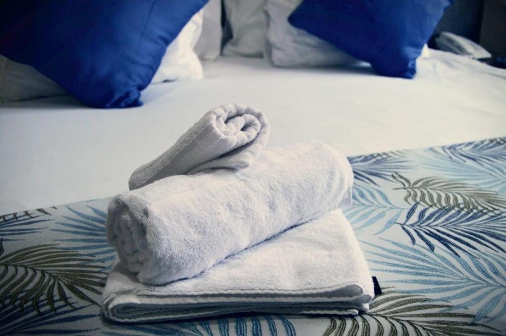 a towel sitting on top of a bed at Essenwood Park Hotel in Durban