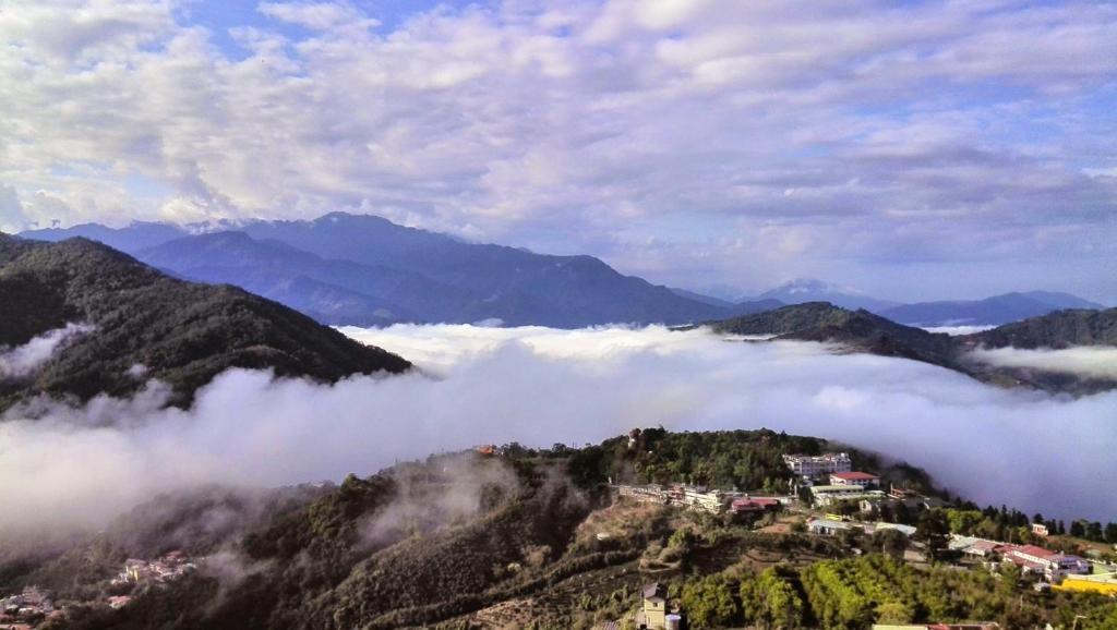 a view of a mountain valley with clouds at Emmanuel Farm House in Ren&#39;ai