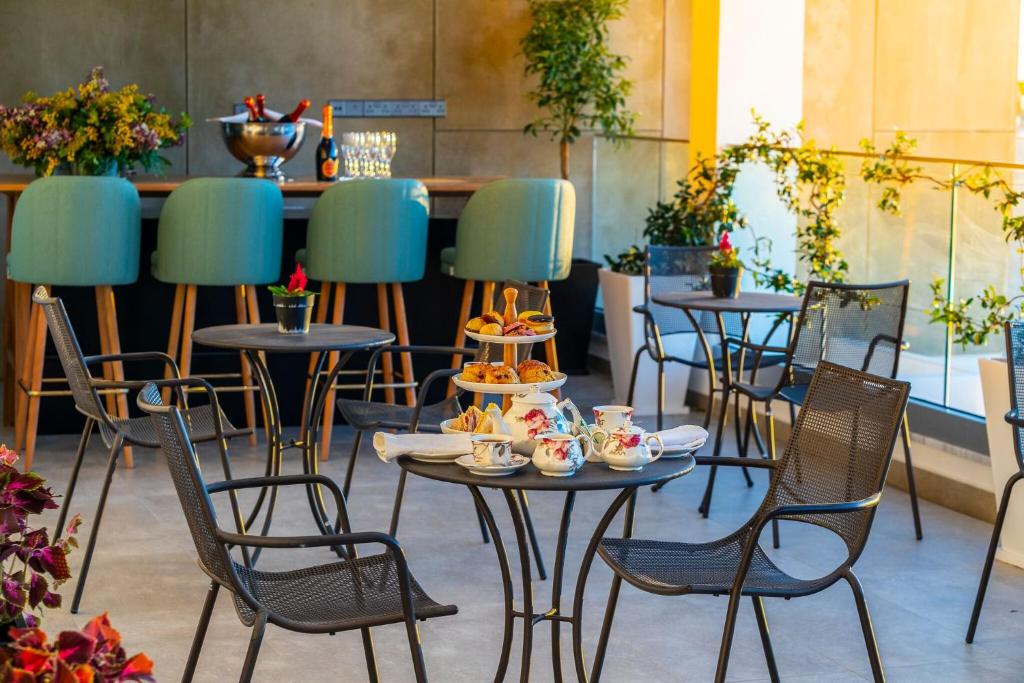 a group of tables and chairs with food on them at Anemi Hotel & Suites in Paphos