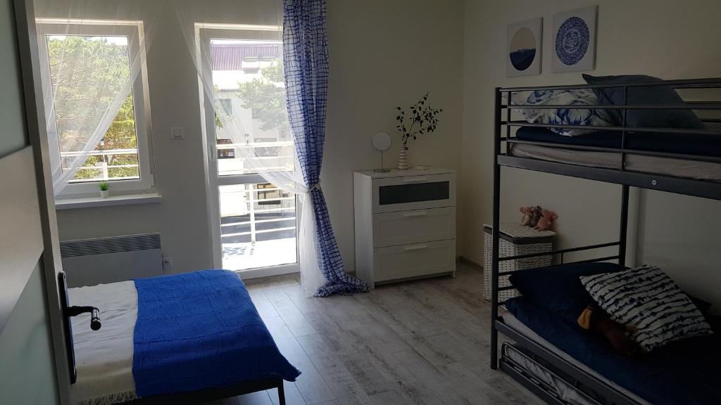 a bedroom with a bunk bed and a window at Apartament Baltic Relax in Rowy
