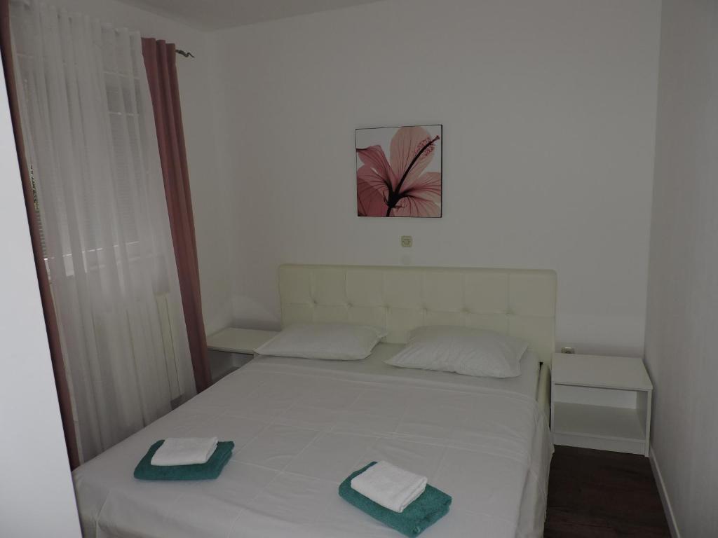 Postel nebo postele na pokoji v ubytování Apartments Lidus