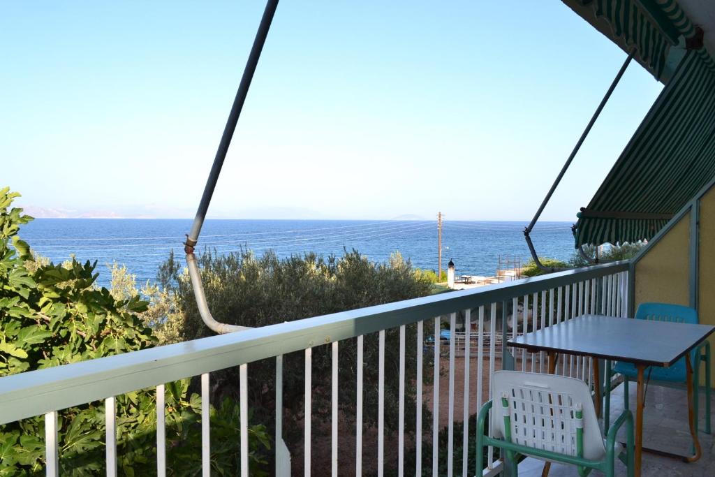 a view of the ocean from the balcony of a house at Oniro Apartments in Xiropigado