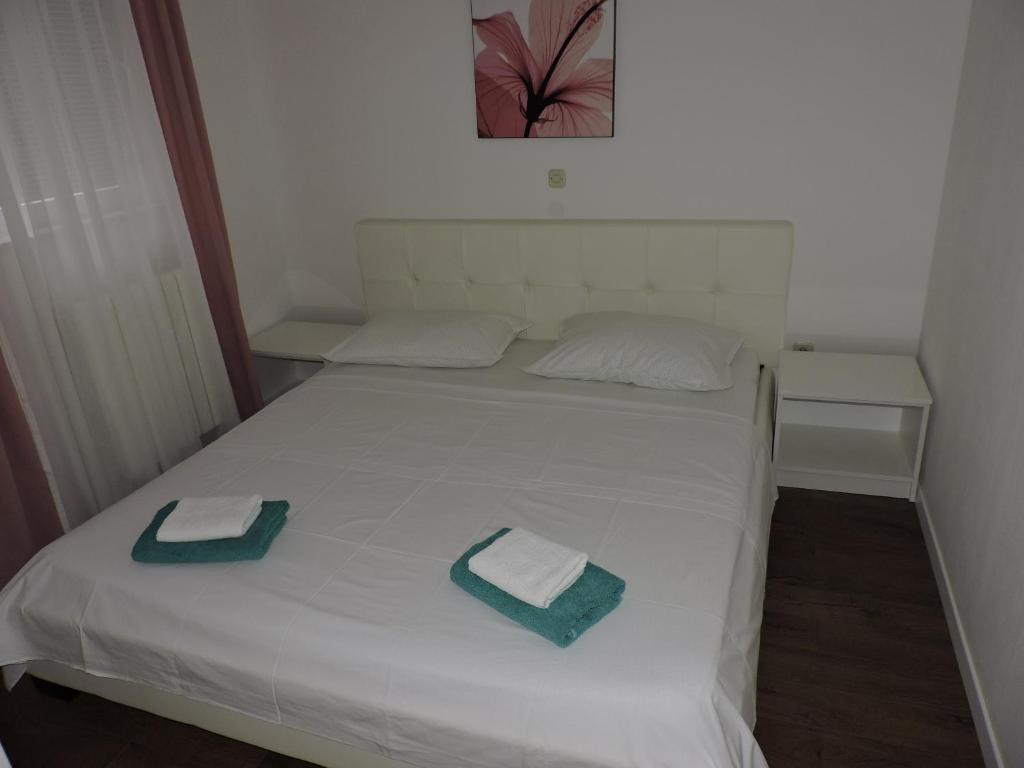 Postel nebo postele na pokoji v ubytování Apartments Lidus