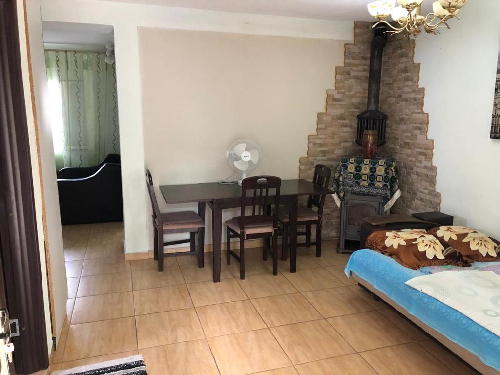 a room with a table and chairs and a dining room at Apartments Dubrava 106 in Dobra Voda