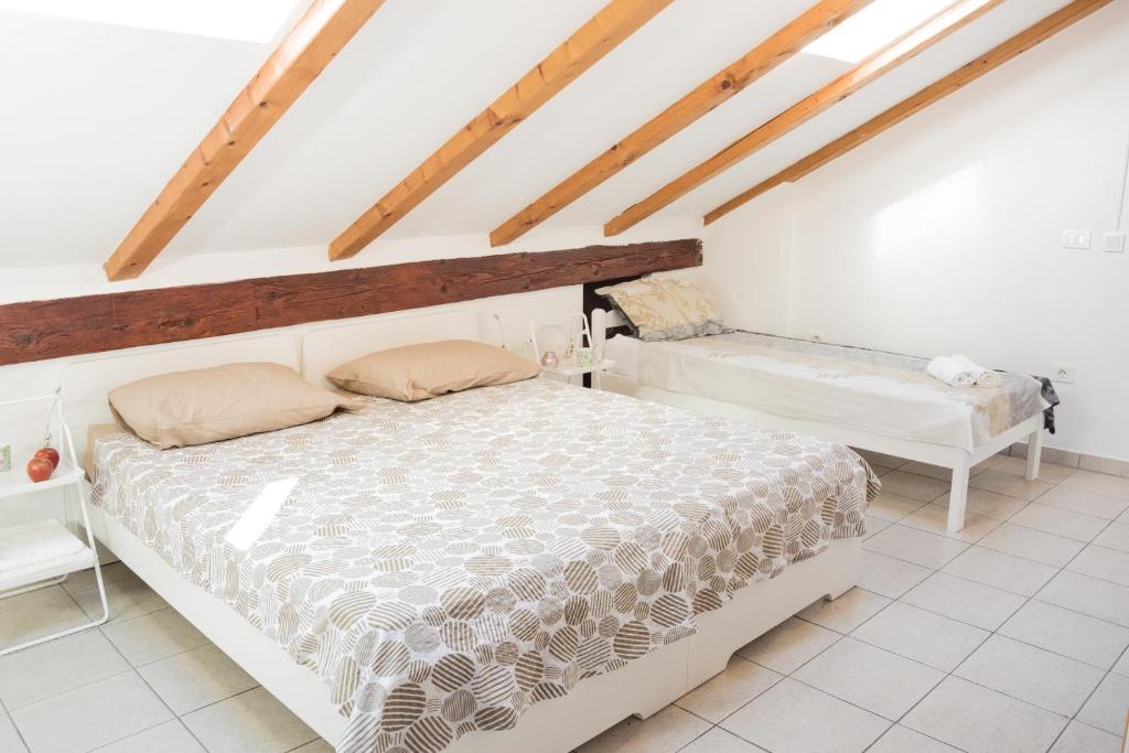 a bedroom with a bed and a bench in a attic at Old City House in Koper