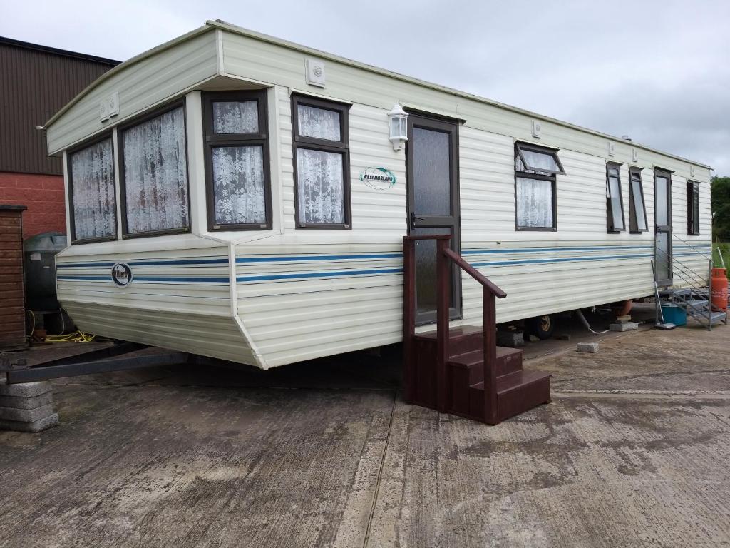 a white trailer parked in a parking lot at 40 AntrimHeights MOBILE self catering can sleep 6 in Antrim