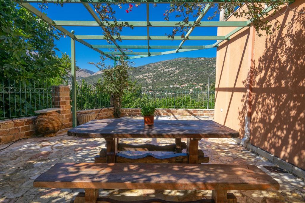 a picnic table with a potted plant on a patio at Anna's apartment in Pilaroú