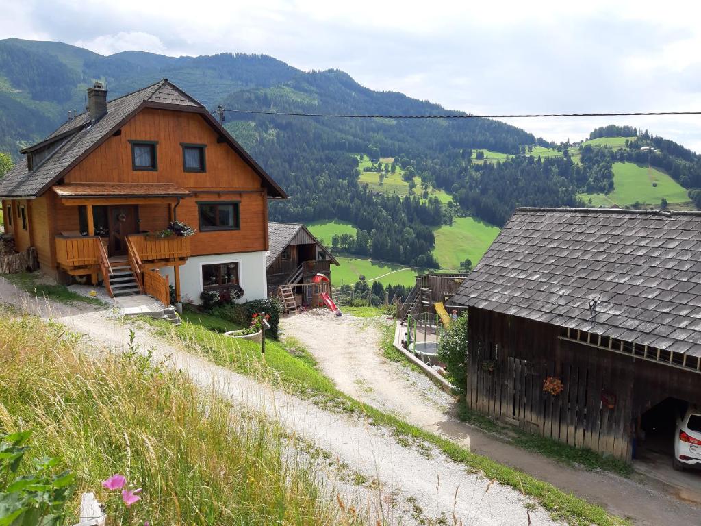 a house on the side of a hill next to a road at Schirfhof in Michaelerberg