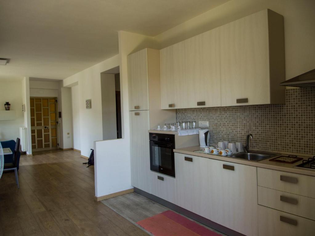 a kitchen with white cabinets and a sink at Valdagri BnB in SantʼArcangelo