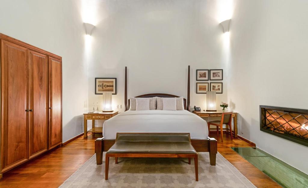 a bedroom with a white bed and a table at Hotel Casa Blanca 7 in San Miguel de Allende