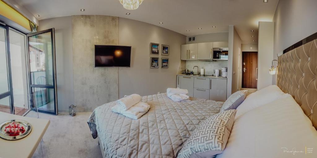 Televízia a/alebo spoločenská miestnosť v ubytovaní Apartament Silence Triventi Cristal
