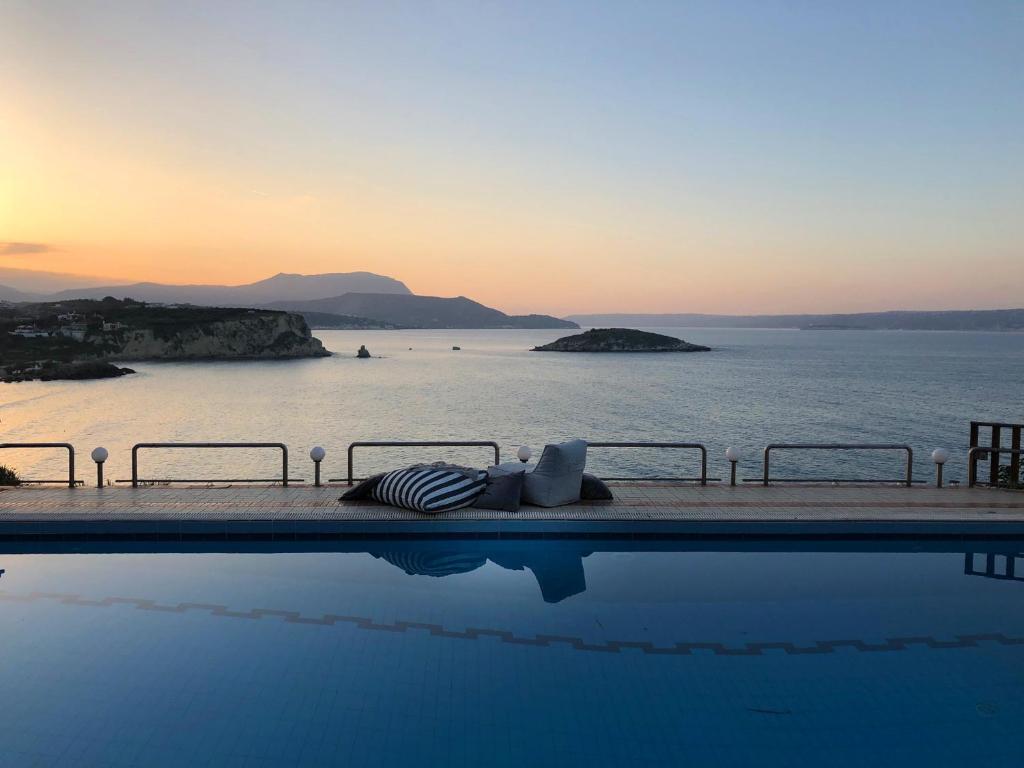 a swimming pool with a view of the ocean at Apartment Sunkiss in Almyrida