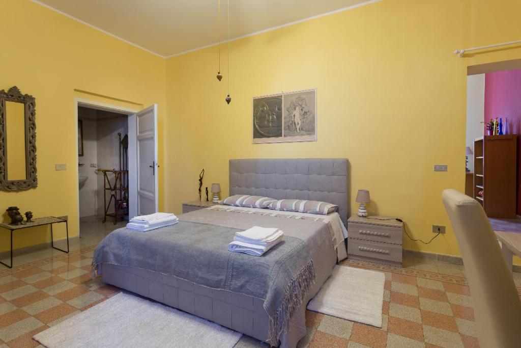 a bedroom with a large bed and yellow walls at Il Profumo del Lauro in Perugia