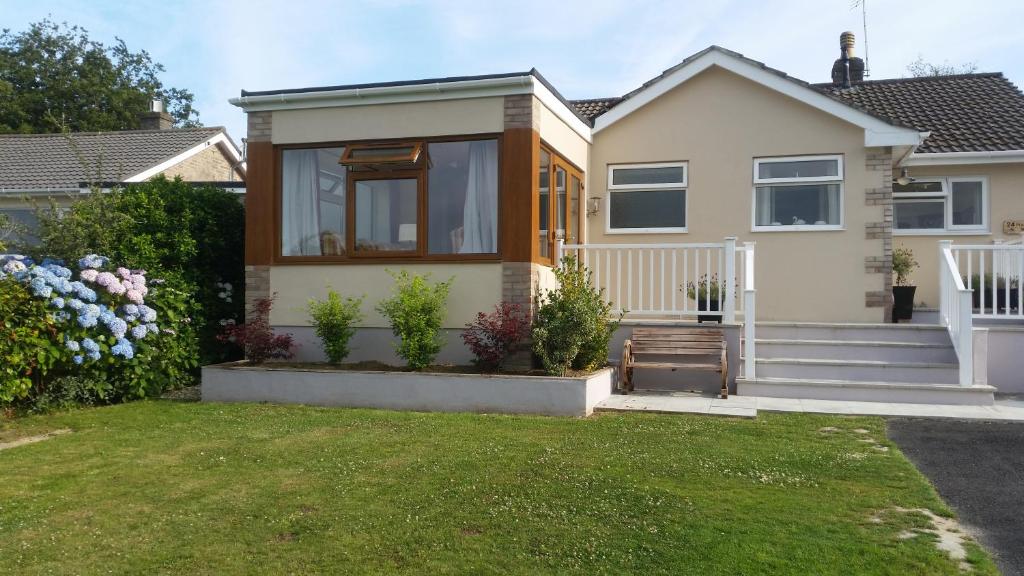 a small house with a lawn in front of it at Seaclusion in St Austell