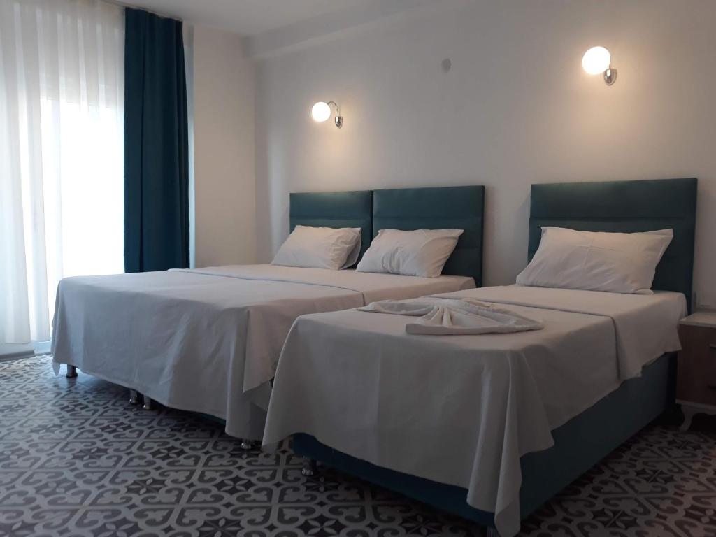 A bed or beds in a room at ada kekiği pansiyon