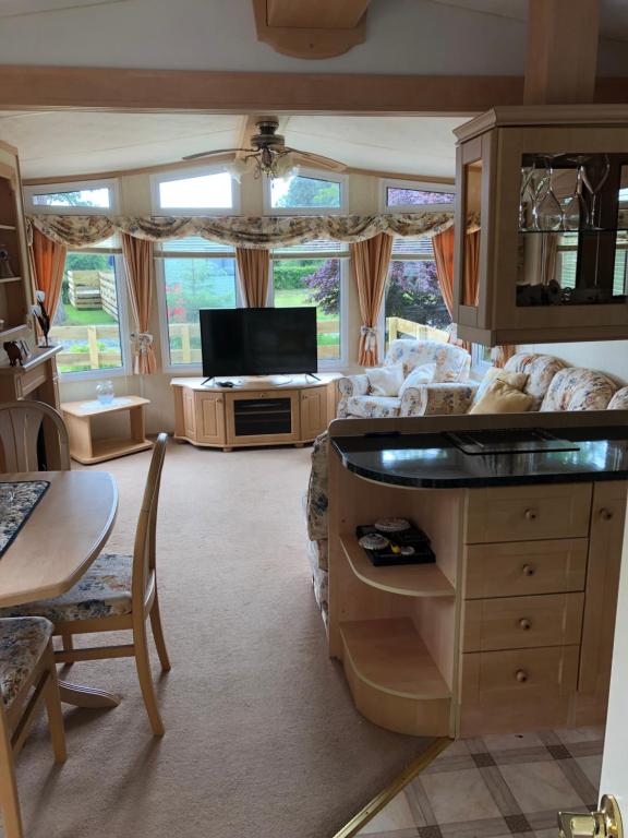 a living room with a couch and a table at The Aspen in Dunoon