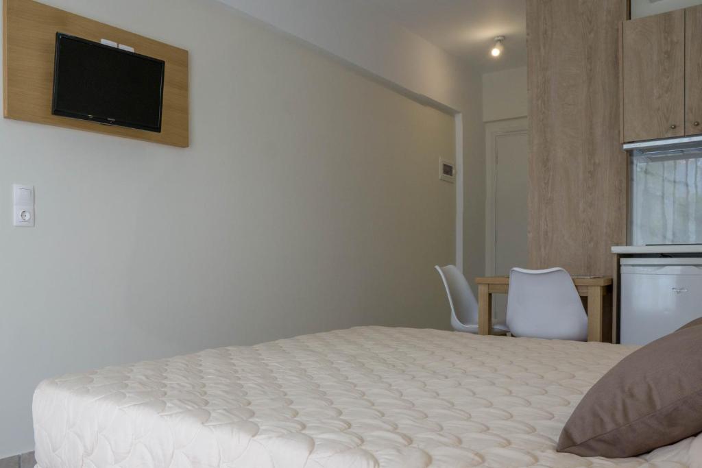 Postel nebo postele na pokoji v ubytování Pinelopi Hotel