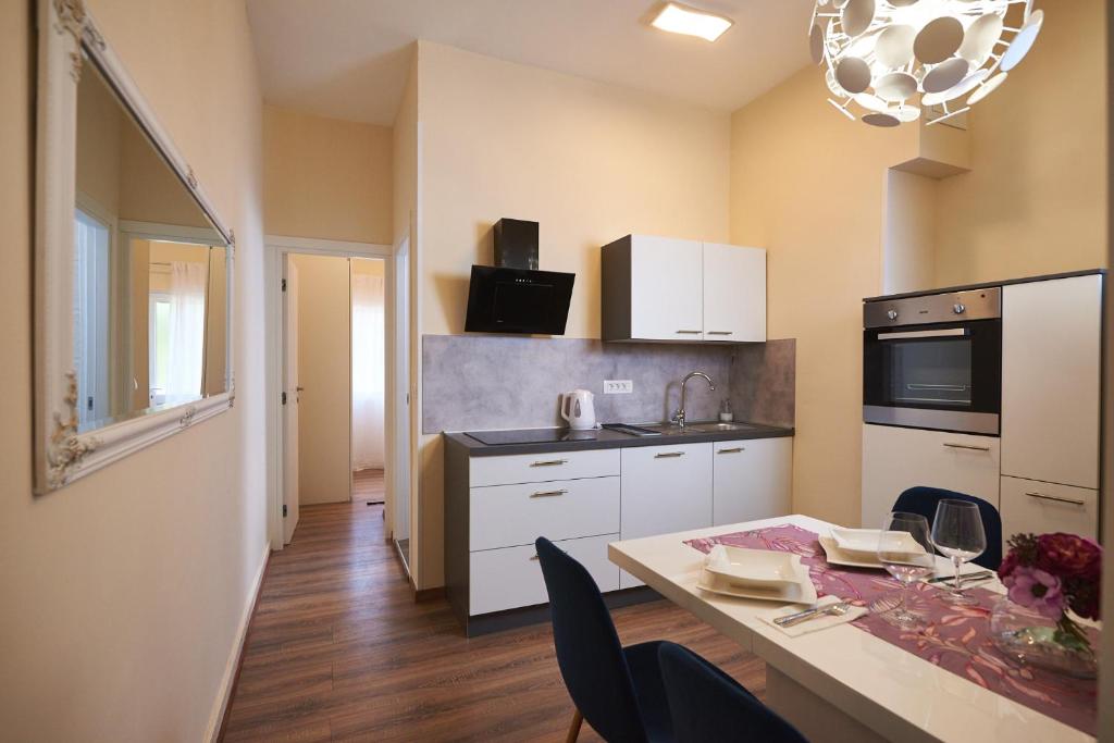 a kitchen with a table with chairs and a dining room at Apartman Nina in Split