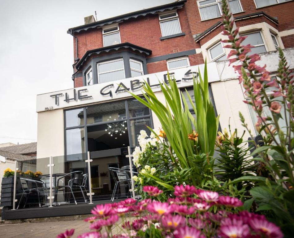 a restaurant with flowers in front of it at The Gables Hotel in Blackpool