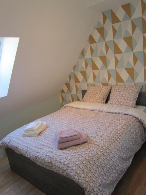 Postel nebo postele na pokoji v ubytování Gîte Faubourg des Pierres