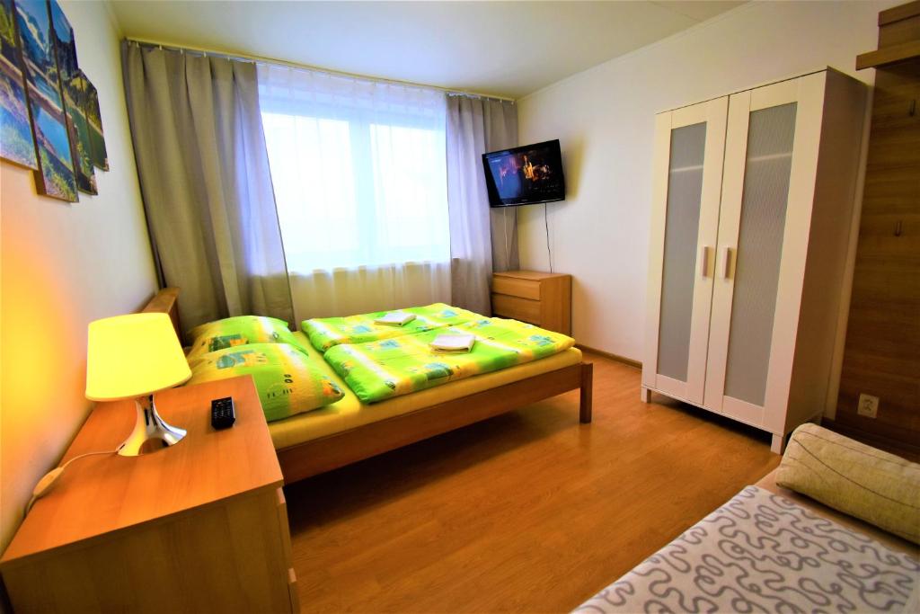 a small bedroom with a bed and a window at Penzion Privat Siesta in Liptovský Mikuláš
