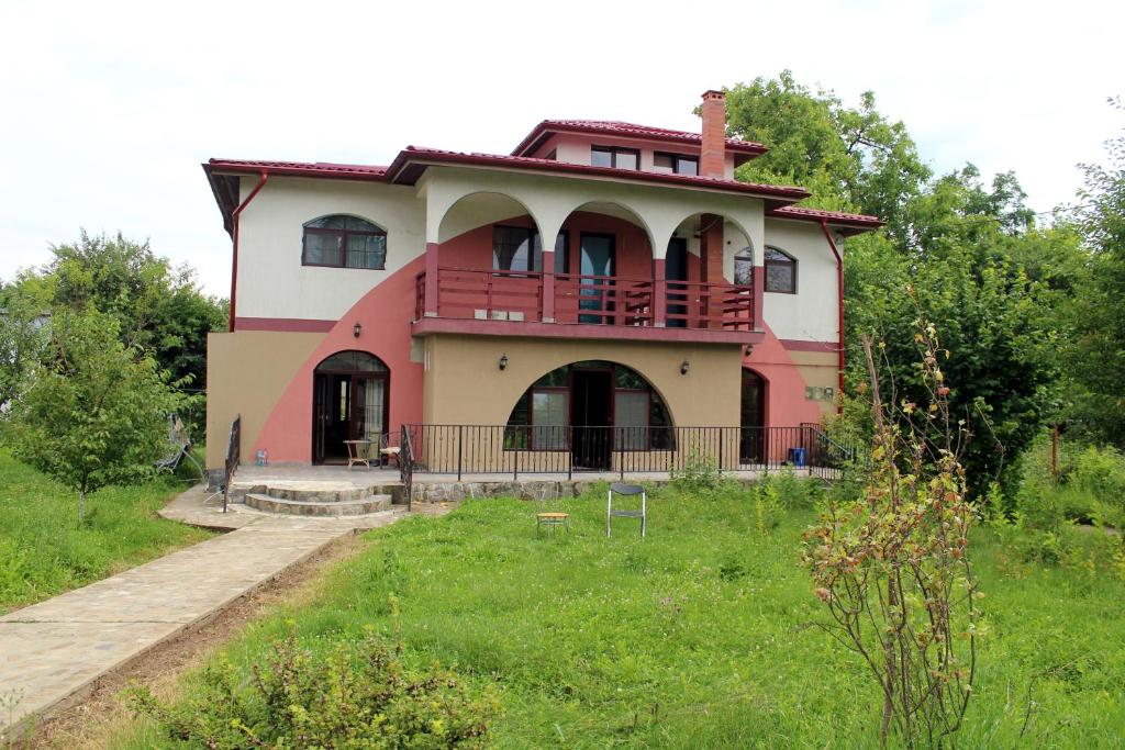a house with a red balcony on top of it at Anuța in Breaza
