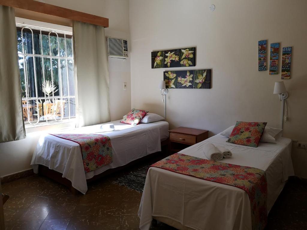 Postel nebo postele na pokoji v ubytování Las Orquideas Parque Hotel