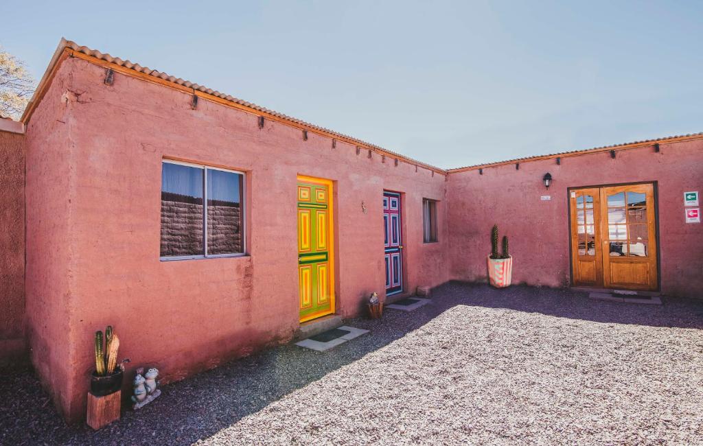 un gruppo di edifici con porte gialle e arancioni di Diablito Atacama Hostel a San Pedro de Atacama