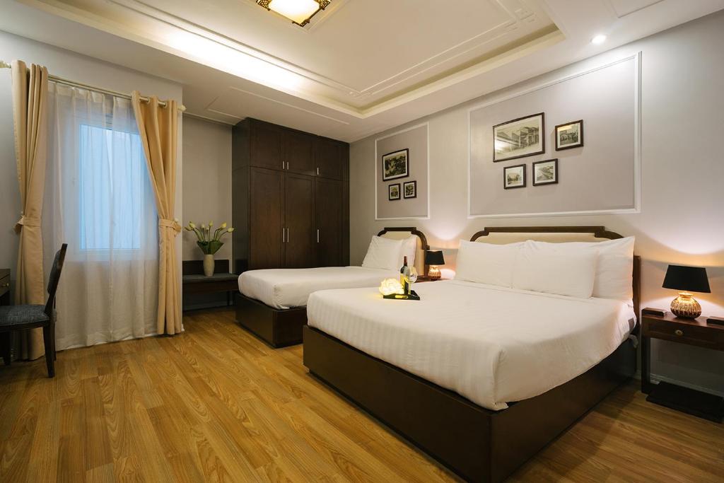 Postel nebo postele na pokoji v ubytování La Palm Hotel