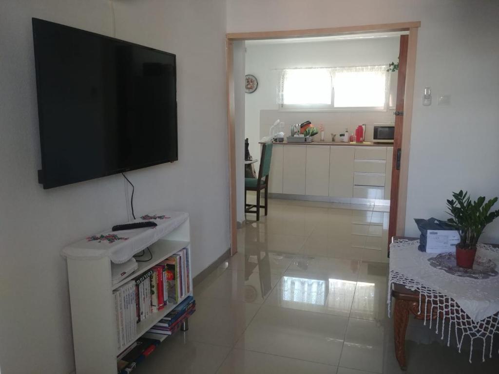 a living room with a flat screen tv on a wall at Apartment for relaxing and for health in Haifa