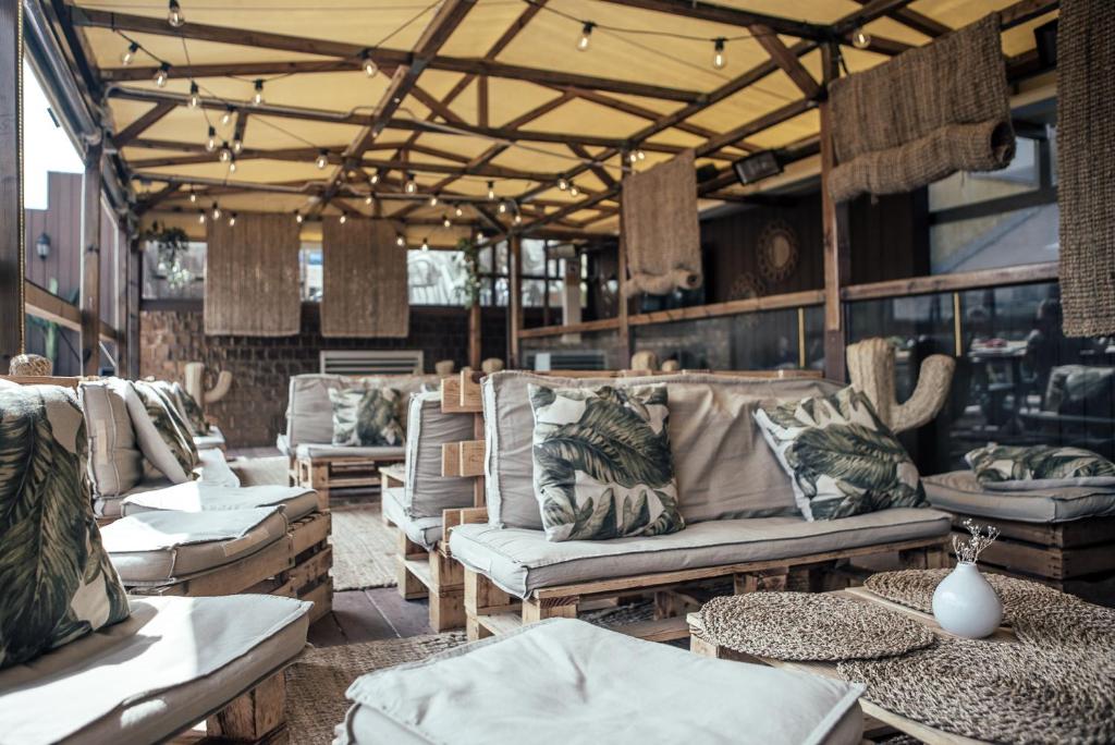 a living room filled with couches and chairs at Kabul Party Hostel Barcelona in Barcelona