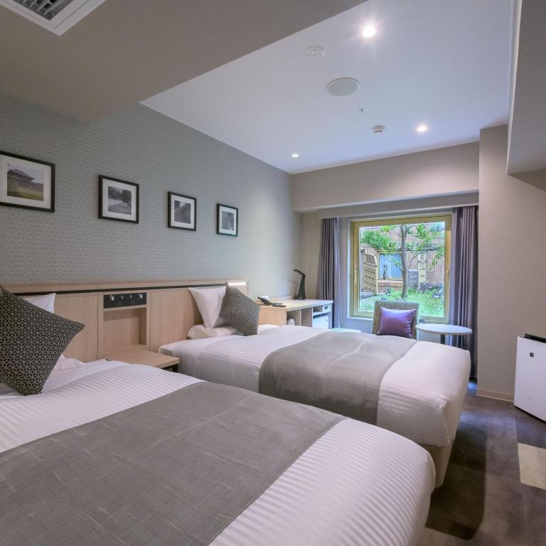 Postel nebo postele na pokoji v ubytování Nara Royal Hotel