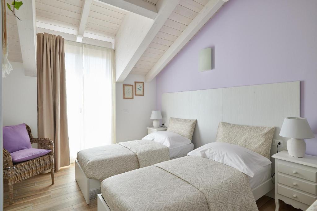 Postel nebo postele na pokoji v ubytování Agriturismo Casastella