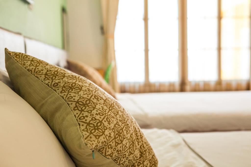 a couch with two pillows on top of it at Summer Ya B&amp;B in Huxi