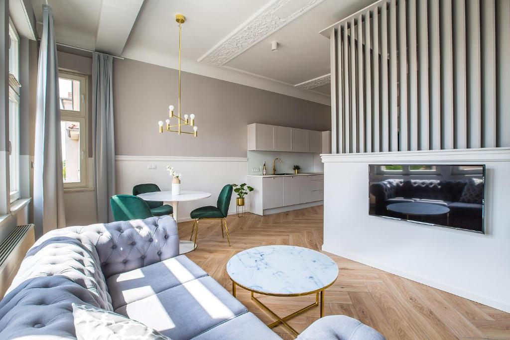a living room with a couch and a fireplace at Homewell Boutique Apartments in Poznań