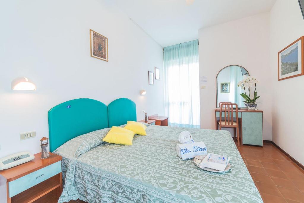 Postel nebo postele na pokoji v ubytování Blu Star Hotel